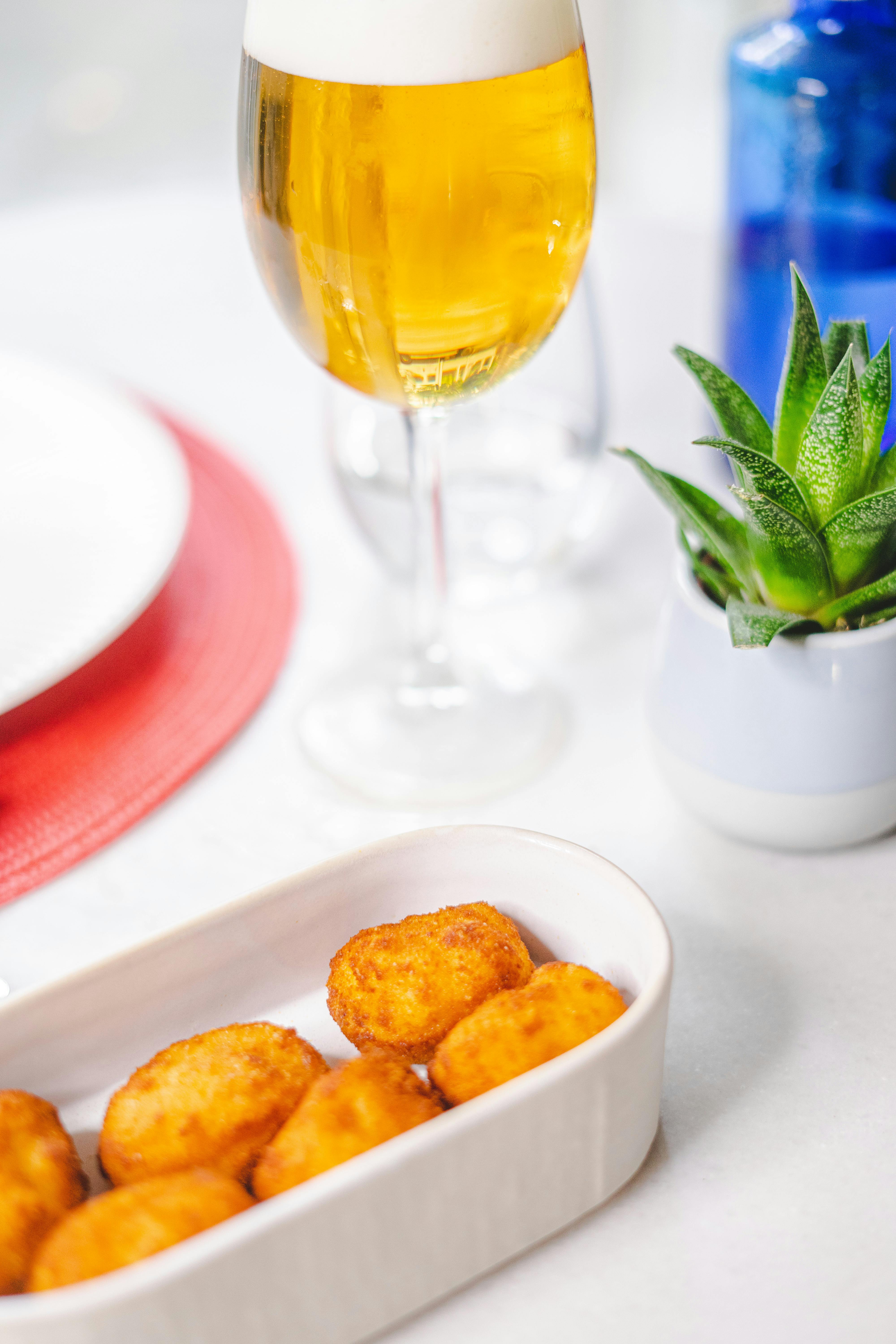 A bowl of delicious tater tots and a glass of Alberta IPA beer.